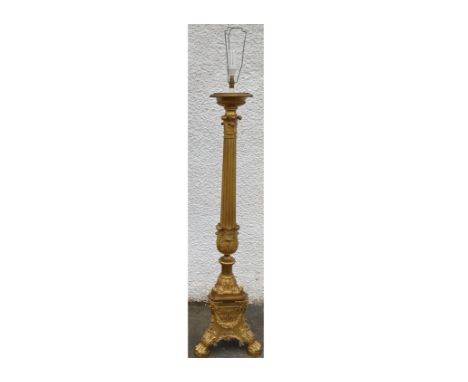 A ormolu standard lamp, in the form of a Corinthian column, raised on a triform base and lion paw feet, 165 cm high