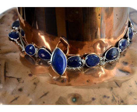 A lapis lazuli chain necklace, stamped 925, 106 cm long, together with a lapis lazuli ring, stamped 925 (2)