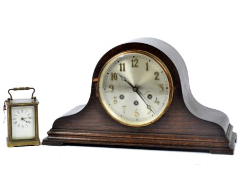 An early 20th Century oak cased Napoleon hat mantel clock, circular metal dial with Arabic numerals and three winding holes, 