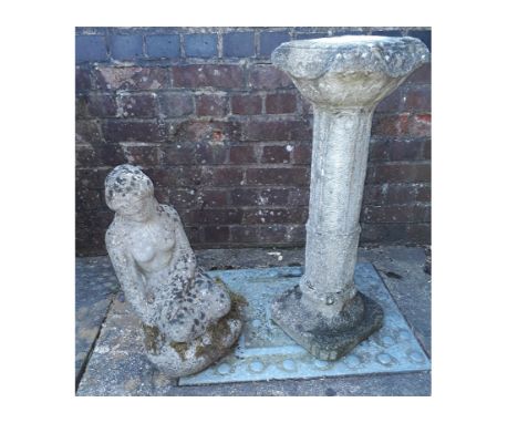 A weathered stone effect sundial pedestal, together with a figure of a seated female nude (2)