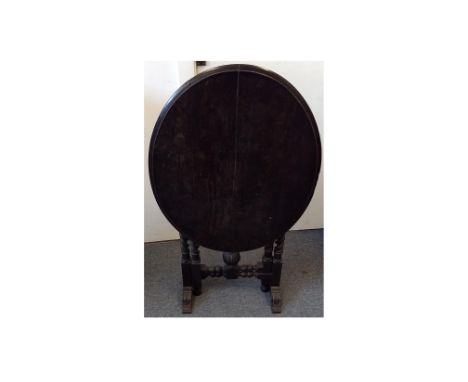A Victorian ebonised oval tilt top table, gate leg barley-twist supports, 82 cm wide x 65 cm deep x 75 cm high