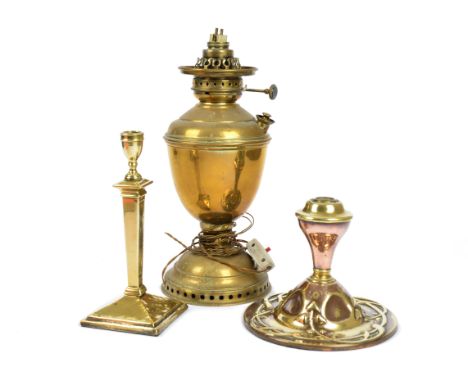 An Art Nouveau copper and brass lamp base, baluster body on circular base, stylised foliate decoration, 18 cm high; together 