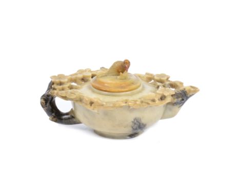 A 19th Century Chinese soapstone teapot, the upper section carved to resemble a floral wreath, with a bird perched on the lid