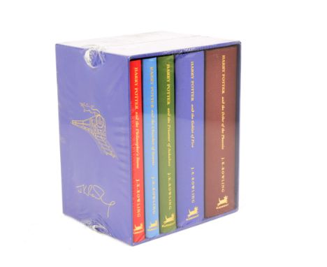 A set of Harry Potter books, the first five volumes bound in coloured fabric and encased within a blue box, plastic wrapping 