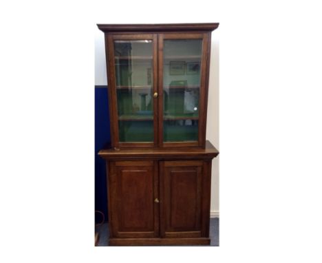 A 19th Century oak elevated glazed bookcase, upper section with two glazed panel doors with fixed shelves, above plinth base 