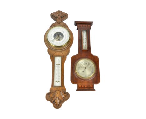 An early 20th Century oak cased aneroid barometer by Benetfink &amp; Co London, with thermometer and carved foliate decoratio