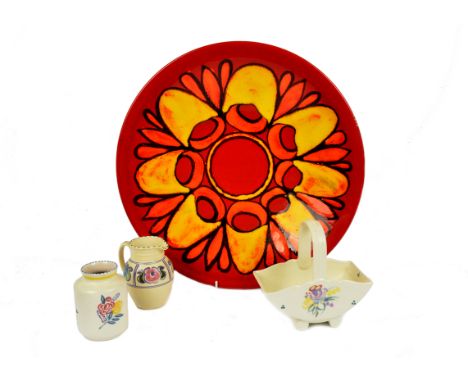 A Poole Pottery Delphis charger, stylised sunburst design in orange and yellow on red ground, shape 54, 41 cm diameter; toget