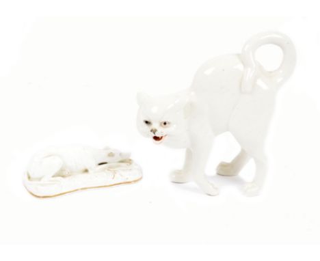 A late 19th/early 20th Century ceramic model of a white cat, glass eyes, 15.5 cm high; together with a white and gilt highlig