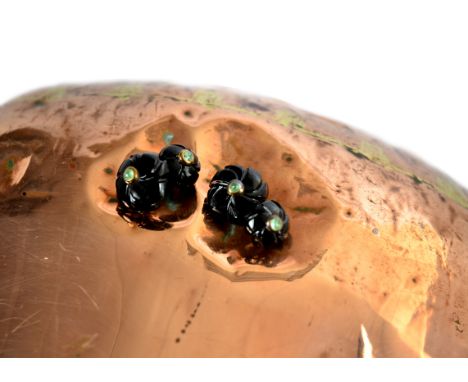 A pair of onyx and emerald cufflinks, carved black onyx centred with cabochon emerald united by silver gilt chain