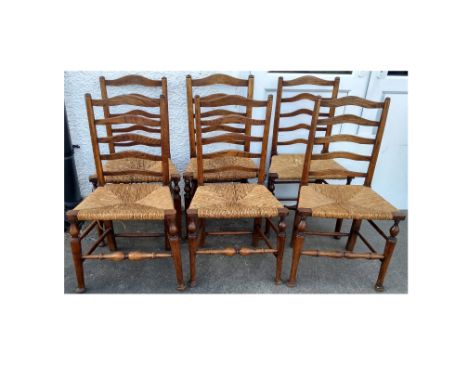 A near set of six antique elm and rush seated ladder back chairs, turned supports and pad feet (6)
