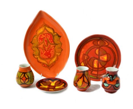 A collection of Poole Pottery Delphis range ware, including bowls, spear dishes, vases, pin trays and other items, decorated 