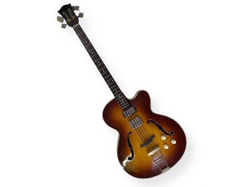 A vintage Hofner bass guitar with two pickup volume knobs. The label on the inside of the bass reads 'no. 732, Bass model: 51