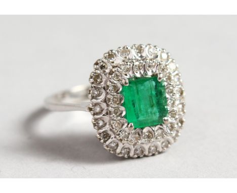 AN 18CT WHITE GOLD, DIAMOND AND EMERALD CLUSTER RING.