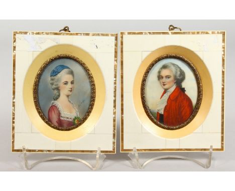 A PAIR OF "PIANO KEY" FRAMED OVAL PORTRAIT MINIATURES, man in a red coat, lady wearing a .purple dress. 5.75ins x 4.75ins.