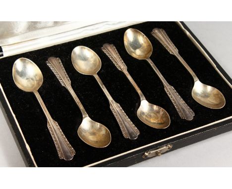 A SET OF SIX TEASPOONS, in a fitted case, stamped silver.