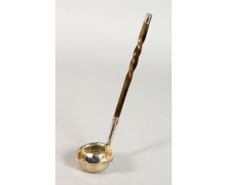 A SILVER TODDY LADLE, with twisted horn handle. Dublin 1820.  Maker: PG.  7ins long.