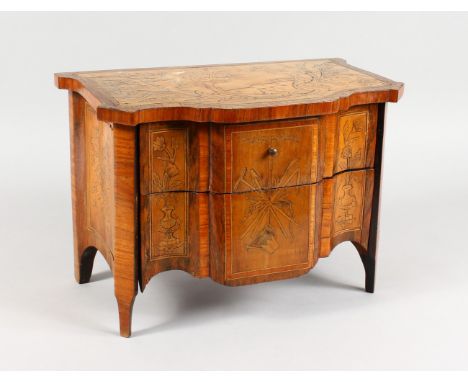 AN APPRENTICE ITALIAN INLAID TWO DRAWER COMMODE, inlaid with a fox, castle, urns etc., with shaped crossbanded top, on curvin