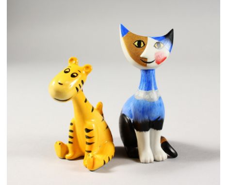 A SMALL GOEBEL FIGURE OF A STYLIZED SEATED CAT and another figure of a tiger, with Walt Disney label. 4ins and 3.25ins high.