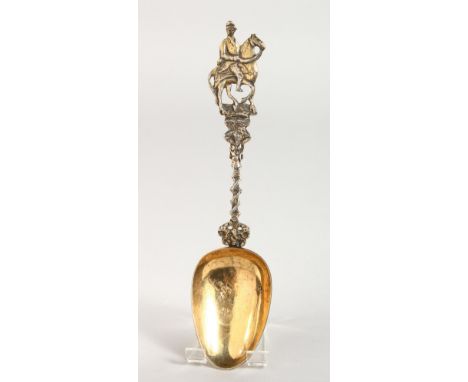 A CONTINENTAL SILVER GILT SPOON, with a cast handle depicting a horse and jockey. 8ins long.