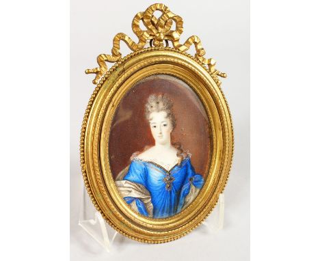 A GOOD 19TH CENTURY OVAL PORTRAIT MINIATURE, of a lady wearing a blue dress, in an ornate ormolu frame. 6.25ins high.