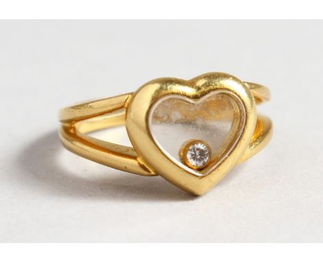 AN 18CT GOLD CHOPARA DIAMOND SET HEAVY SHAPED RING.