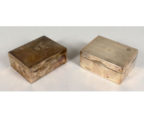 TWO ENGINE TURNED SILVER CIGARETTE BOXES. Both 4.5ins long.