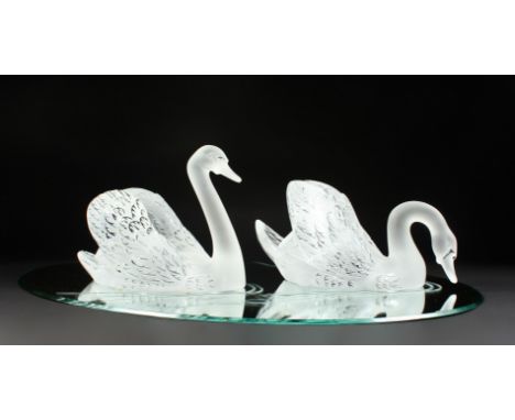 A SUPERB LALIQUE SWAN TABLE CENTREPIECE formed as two swans, 14ins long, standing on a large oval mirrored plateau, 32ins x 2