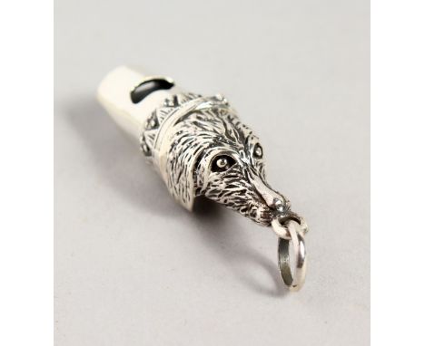 A TINY NOVELTY SILVER DOG'S HEAD WHISTLE.