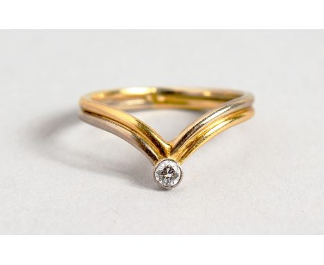 AN 18CT GOLD DIAMOND SET WISHBONE RING.
