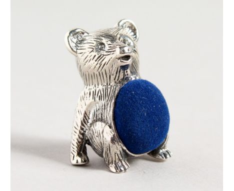 A NOVELTY SILVER TEDDY BEAR PIN CUSHION.