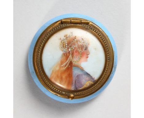 A SMALL CIRCULAR PORCELAIN AND METAL MOUNTED BOX, the hinged lid painted with a portrait of a lady. 2.25ins diameter.