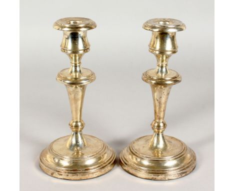 A PAIR OF CIRCULAR SILVER CANDLESTICKS. Stamped Argentina 925, 32ozs, weighted bases.  8.5ins high.