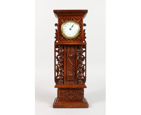 A CARVED OAK MINIATURE LONGCASE CLOCK, with watch movement. 13.5ins high.