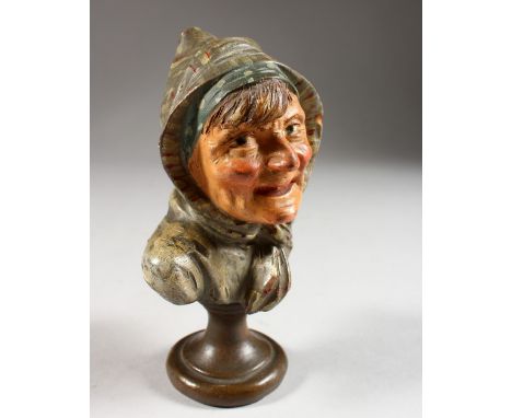 A CONTINENTAL PAINTED TERRACOTTA BUST OF A WOMAN WEARING A HEAD SCARF. 5.5ins high.