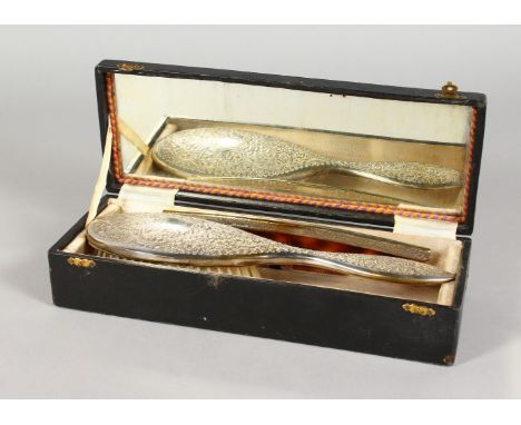 AN EDWARDIAN COMB AND BRUSH SET, cased.