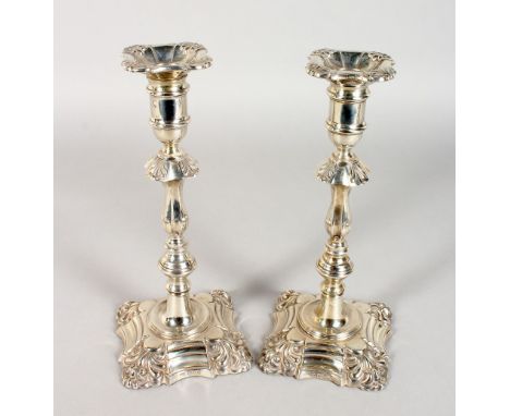 A PAIR OF 18TH CENTURY STYLE SILVER CANDLESTICKS, with shell cast sconces and knopped stems, on shaped bases with anthemion c