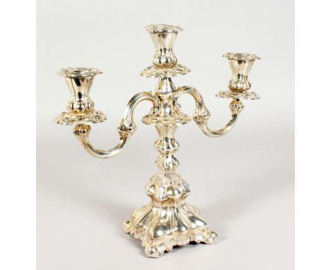 A CONTINENTAL SILVER TWO BRANCH CANDLESTICK, with loaded bases. 12ins high.