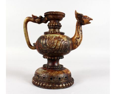 A CHINESE RUSSET JADE JUG with grotesque handle and spout. 9ins high.