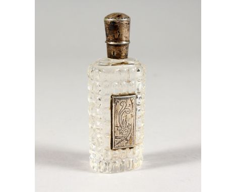 A SILVER MOUNTED CUT GLASS PERFUME BOTTLE. 3.5ins high.