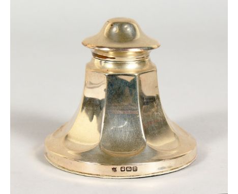 A SILVER INKWELL, with hinged lid, moulded body and circular base. Sheffield 1914.  3.25ins high.