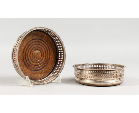 A PAIR OF PLATED CIRCULAR WINE BOTTLE/DECANTER COASTERS, with pierced sided. 5.25ins diameter.