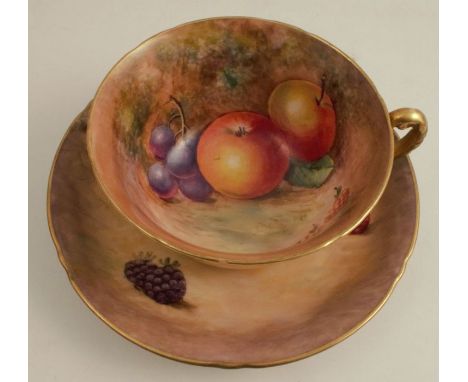 A Royal Worcester tea cup and saucer, decorated with hand painted fruit by Cook and Smith, the cup chipped