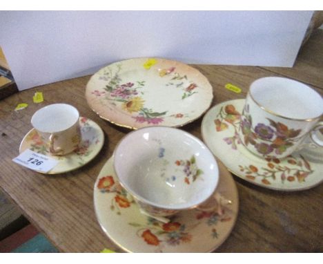 A Royal Worcester blush ivory cup and saucer, together with a miniature example, a side plate, and a cup and saucer decorated