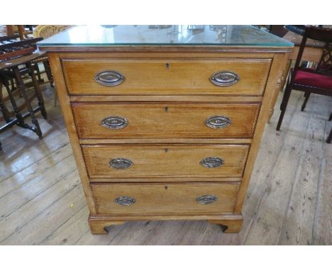 An Edwardian mahogany chest of drawers, with cross banded decoration, having four graduated drawers, raised on bracket feet, 