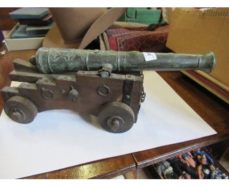 A model canon, on a wheeled wooden base