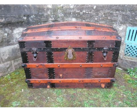 A domed top trunk, with metal and wooden bands, width 33ins x height 28ins