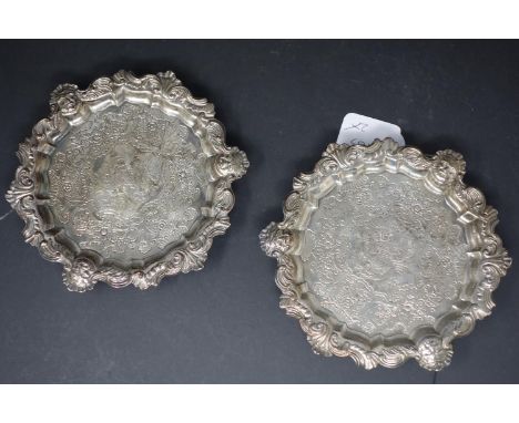 A pair of George II silver salvers by Benjamin Godfrey, London 1739, each circular and on three reeded panel feet, with reede