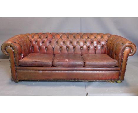 A three seater leather Chesterfield sofa, with button back upholstery, heavily worn, H70cm, W210cm, D92cm 