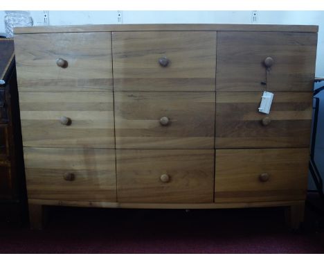 A contemporary hardwood bow fronted chest of 9 drawers, H.93 W.131 D.49cm 