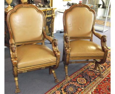 OPEN ARMCHAIRS, a pair, late 19th century Egyptian revival walnut and parcel gilt in light tan leather with sphynx arm suppor